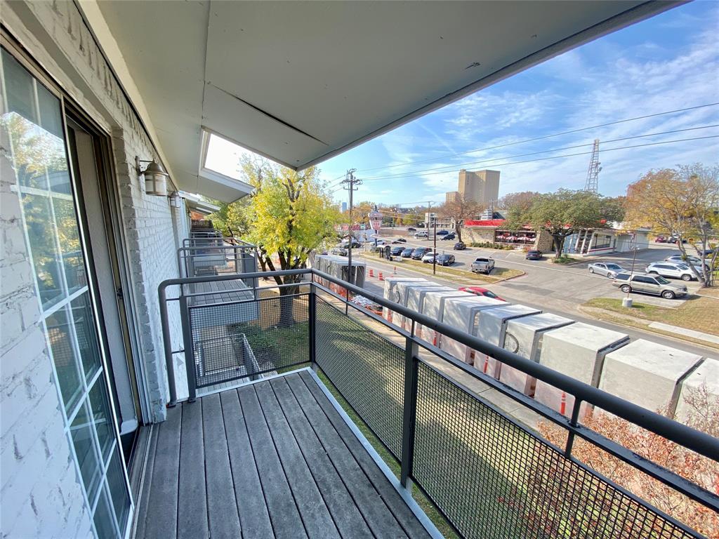 4502 Gaston Avenue, Unit 322 Dallas, TX 75246 - Photo 16 of 17 a view of a balcony with furniture and wooden floor