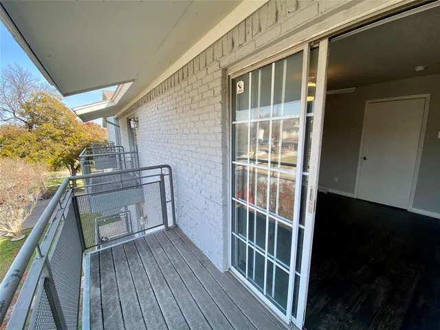 a view of a balcony with wooden floor