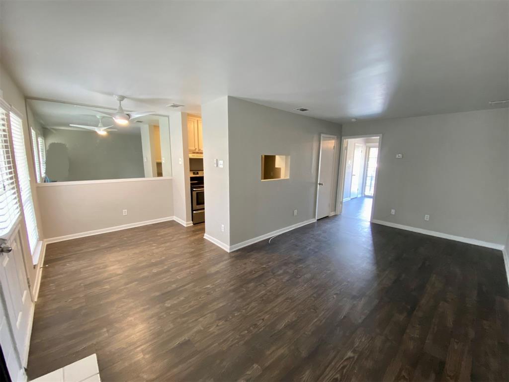 4502 Gaston Avenue, Unit 322 Dallas, TX 75246 - Photo 5 of 17 an empty room with wooden floor and windows