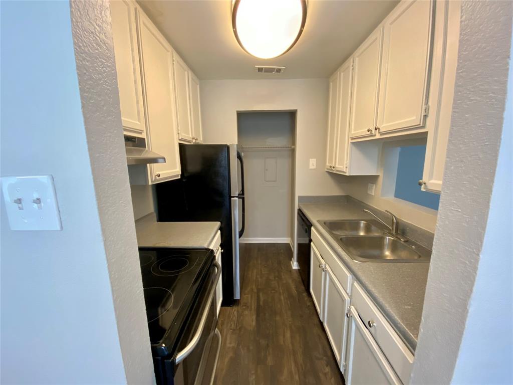 4502 Gaston Avenue, Unit 322 Dallas, TX 75246 - Photo 7 of 17 a kitchen with a sink a refrigerator and cabinets