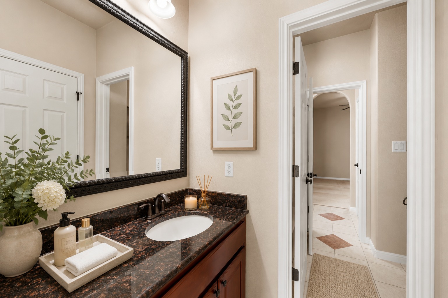 3903 Remington Road Cedar Park, TX 78613 - Photo 17 of 29 A dark granite vanity with a single basin complements the elegant framed mirror in this well-appointed bathroom.