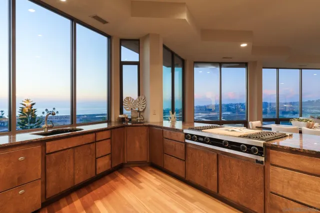 a kitchen with a large window and cabinets