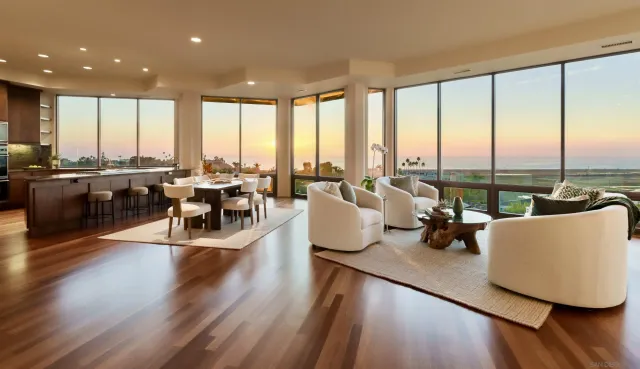 a living room with furniture and floor to ceiling windows