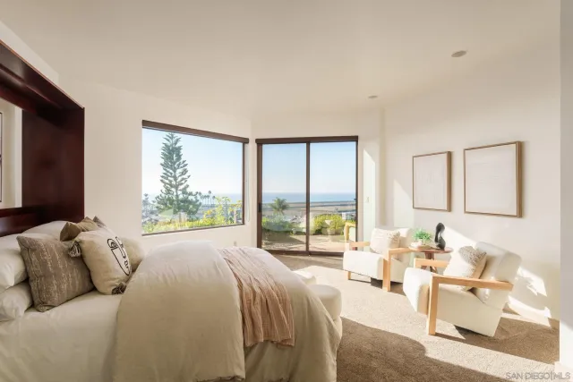 a bed room with a bed and a large window