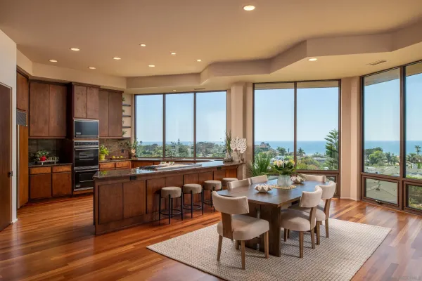 a large kitchen with a table and chairs