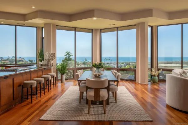a living room with furniture and floor to ceiling windows