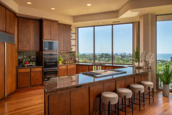 a kitchen with stainless steel appliances wooden floor dining table and chairs