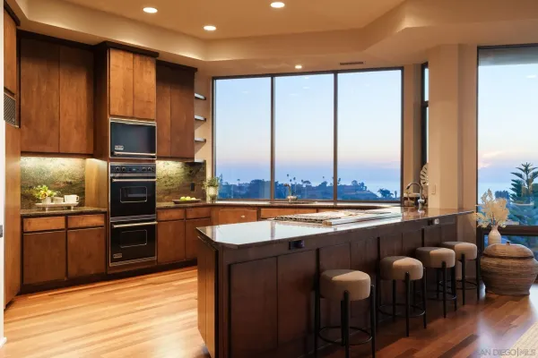 a large kitchen with a large window and stainless steel appliances