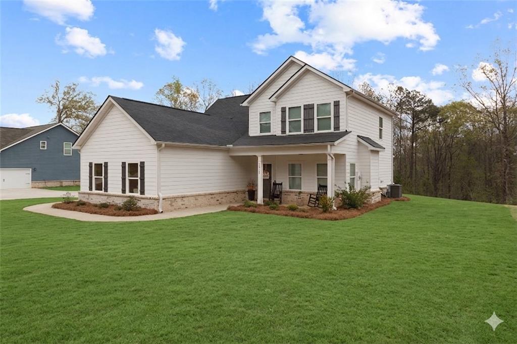 171 Strickland Loop Forsyth, GA 31029 - Photo 23 of 25 a view of a house with a yard and sitting area
