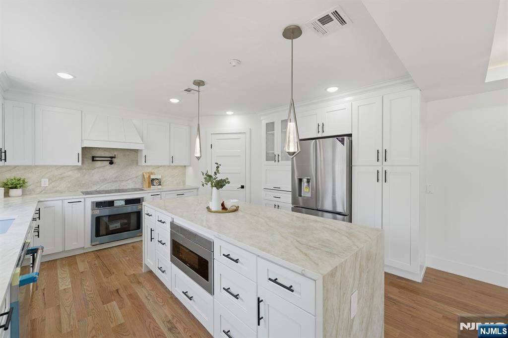 275 Longview Road Union, NJ 07083 - Photo 15 of 43 a kitchen with stainless steel appliances granite countertop a refrigerator a stove a sink and a oven