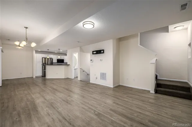 a view of a kitchen with a sink and a refrigerator
