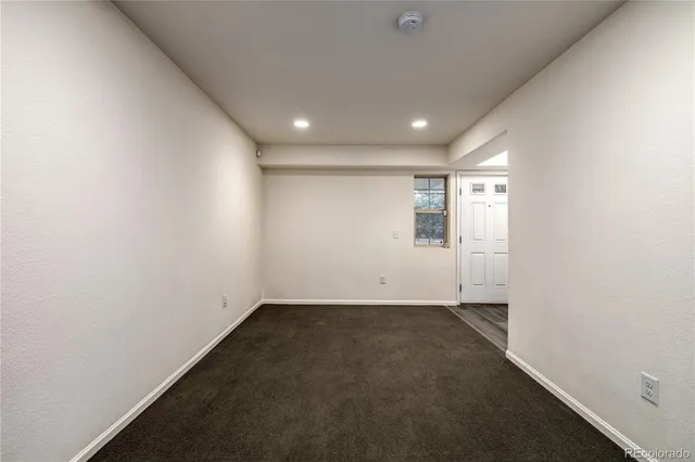 an empty room with a empty space and windows