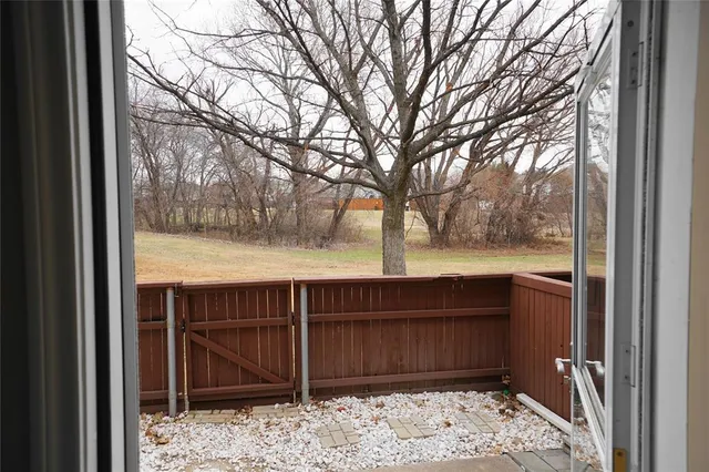 a view of a wooden fence next to a yard