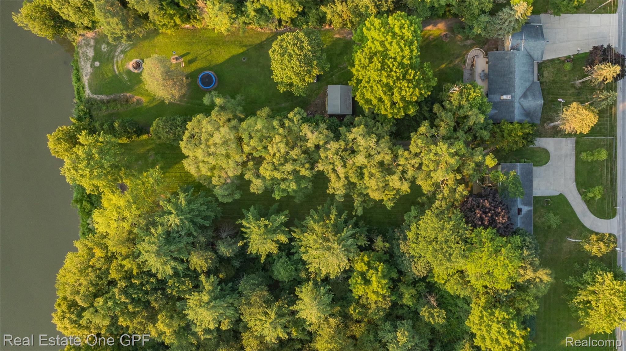 5068 Atkins Road North Street, MI 48049 - Photo 67 of 78 Expansive wooded property featuring two residential structures, a tranquil waterfront, and paved driveways