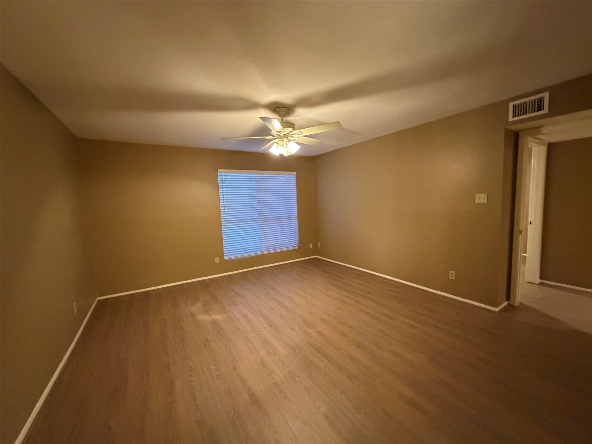 14515 Wunderlich Drive, Unit 703 Houston, TX 77069 - Photo 13 of 25 an empty room with a empty space and a ceiling fan