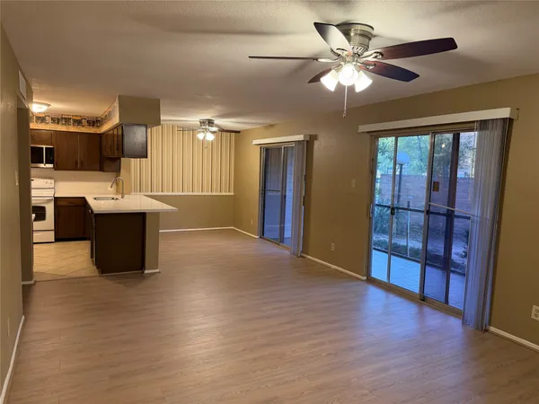 a view of kitchen with cabinets and wooden floor