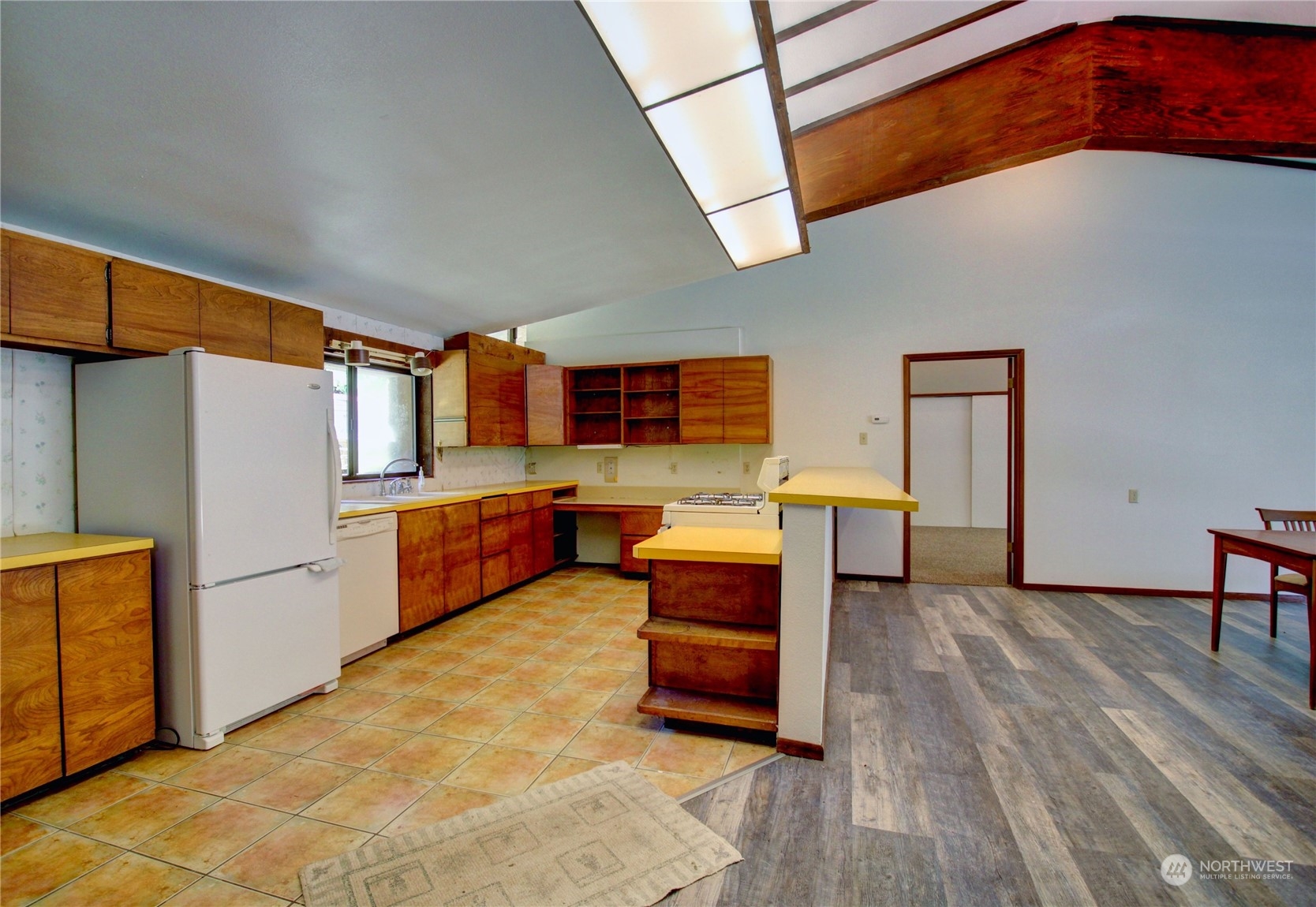 13709 Rector Road Bow, WA 98232 - Photo 9 of 36 a kitchen with stainless steel appliances kitchen island granite countertop furniture and a refrigerator