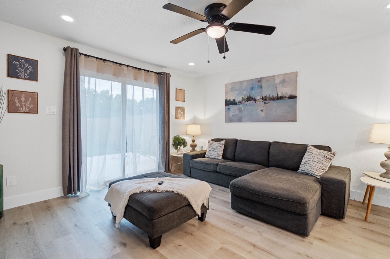 3138 Sunbeam Street Houston, TX 77051 - Photo 10 of 50 Bright, open, and beautifully staged, this living space offers the ideal mix of comfort and style with natural light pouring through expansive sliding glass doors.