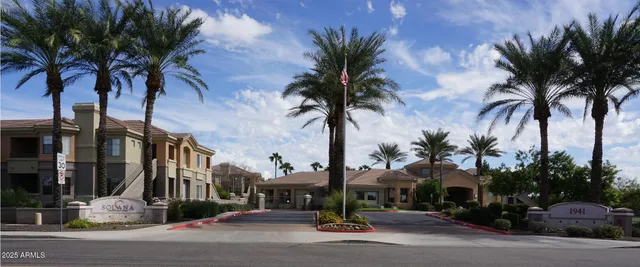 a view of a street with palm trees
