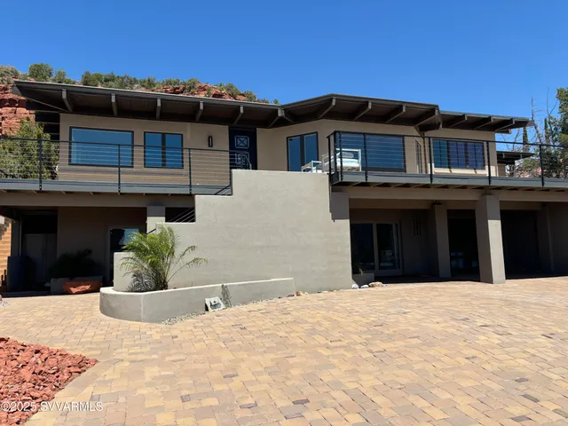 a view of a house with a potted plant and a chair