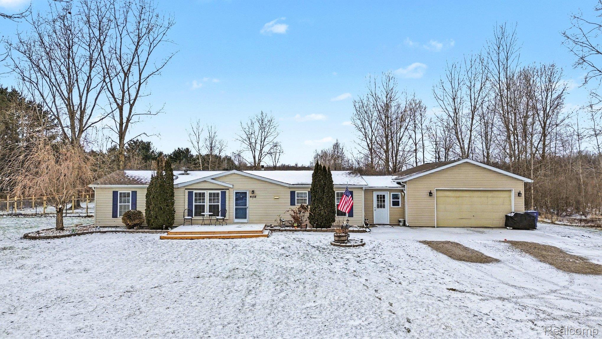 4458 Palms Road Casco, MI 48064 - Photo 27 of 32 Ranch-style home featuring a wooden deck and a garage