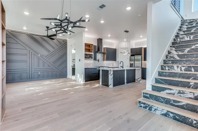 a view of a kitchen with a sink and ceiling fan