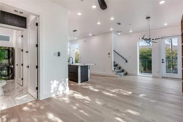 a view of a hallway with wooden floor and staircase