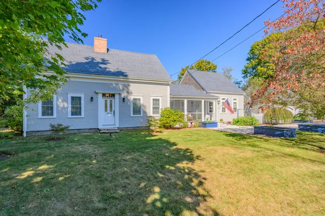a view of a house with swimming pool and a yard