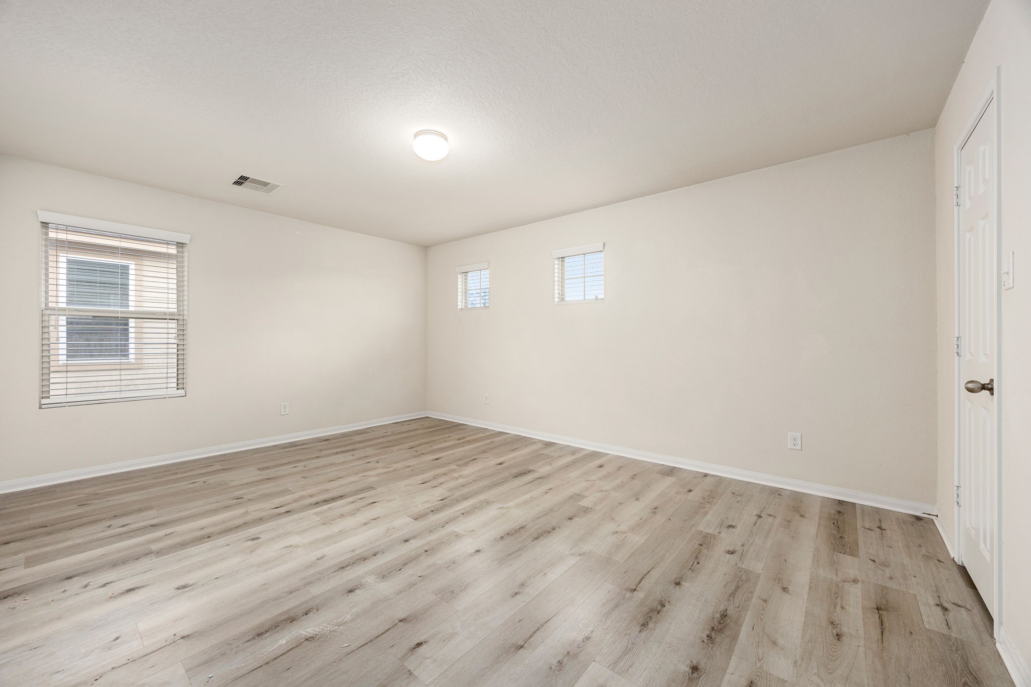 29322 Indian Clearing Spring, TX 77386 - Photo 30 of 47 an empty room with wooden floor and windows