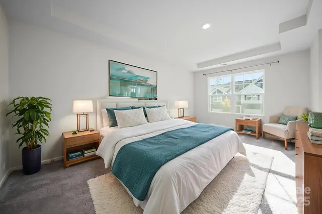 a bedroom with bed plant and window