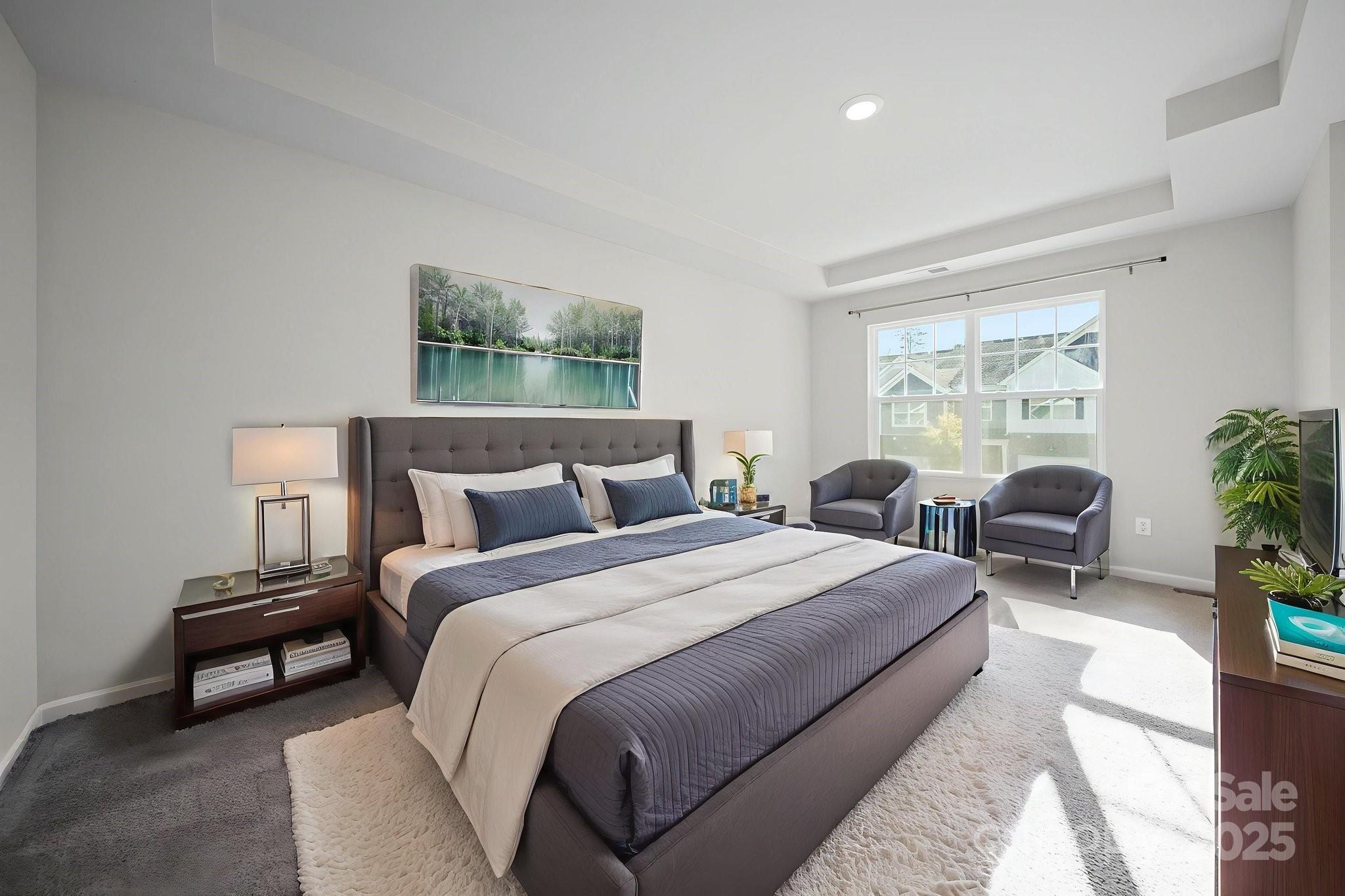 808 Gable Oak Lane Fort Mill, SC 29708 - Photo 26 of 41 a spacious bedroom with a bed a couch and potted plant with two windows