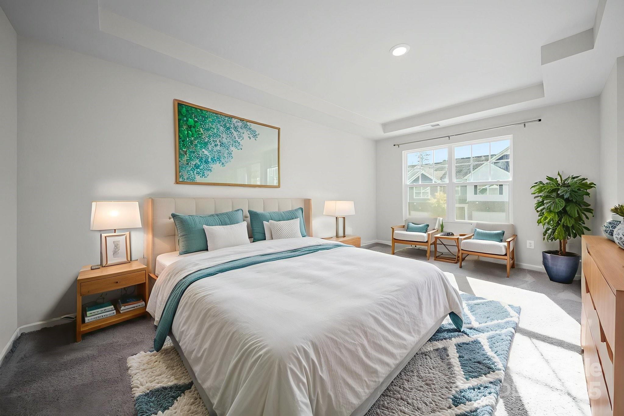 808 Gable Oak Lane Fort Mill, SC 29708 - Photo 27 of 41 a spacious bedroom with a bed a table and a potted plant