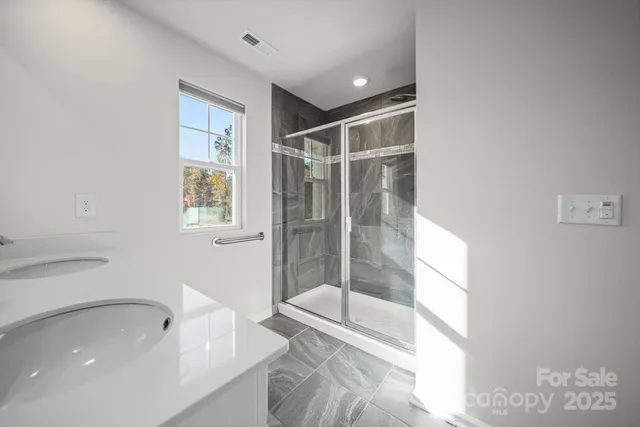 a bathroom with a bathtub and a shower