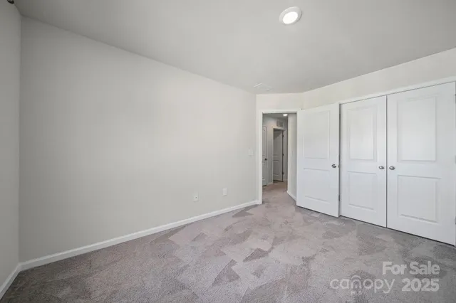 a view of an empty room and closet area