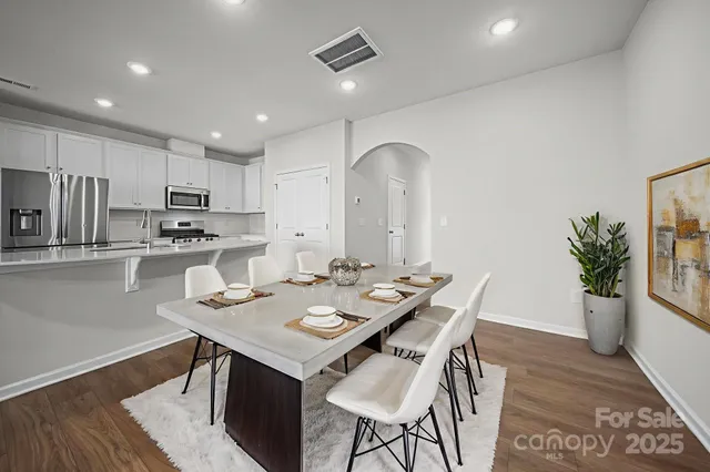 a kitchen with a table and chairs in it