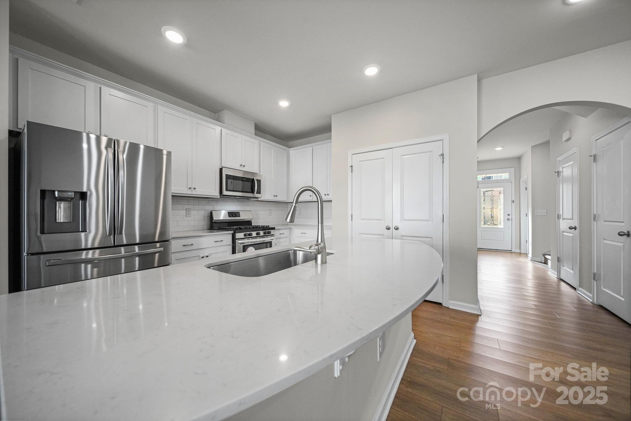 808 Gable Oak Lane Fort Mill, SC 29708 - Photo 10 of 41 a kitchen with stainless steel appliances a refrigerator stove microwave and sink