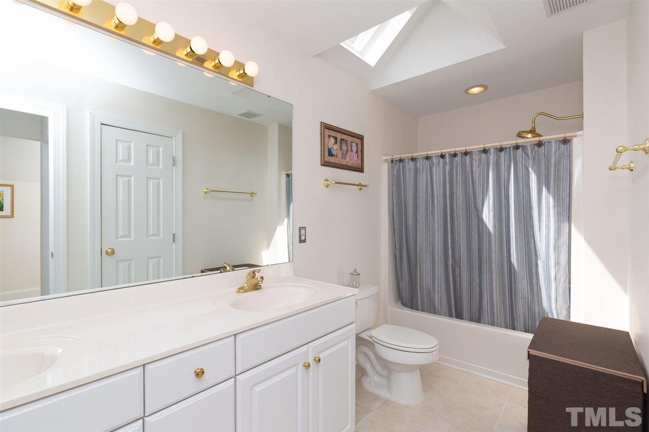 12613 Raven Ridge Road Raleigh, NC 27614 - Photo 22 of 29 a bathroom with a sink a toilet and shower