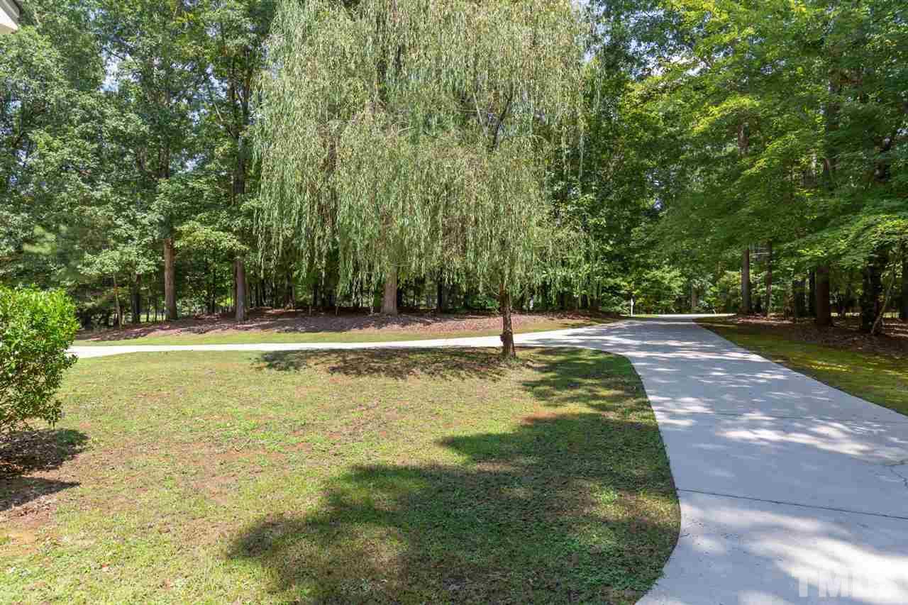 12613 Raven Ridge Road Raleigh, NC 27614 - Photo 4 of 29 a view of a swimming pool with a yard