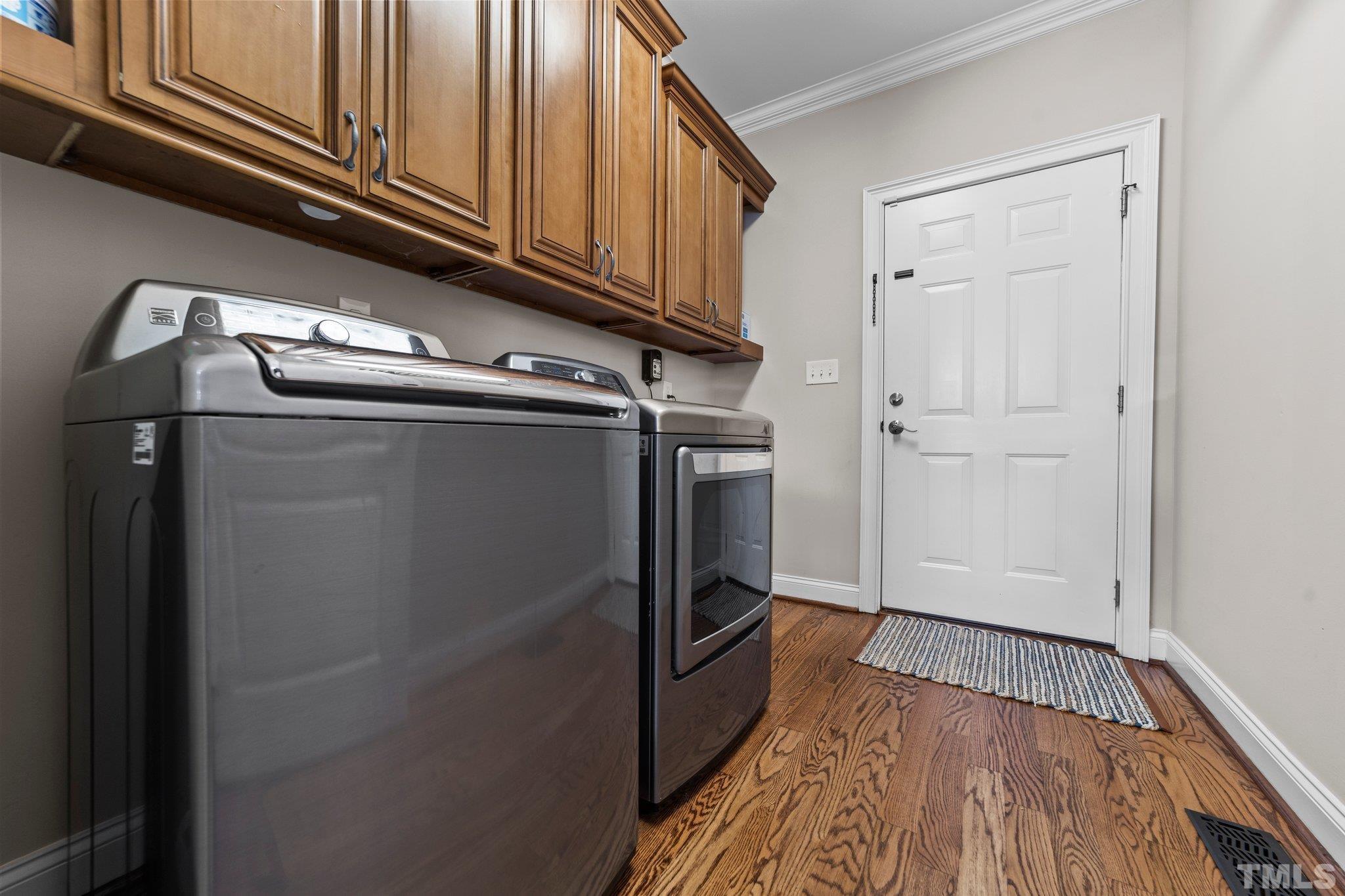 213 Serendipity Drive Haw River, NC 27258 - Photo 23 of 33 a view of a kitchen with stainless steel appliances wooden floor and cabinets