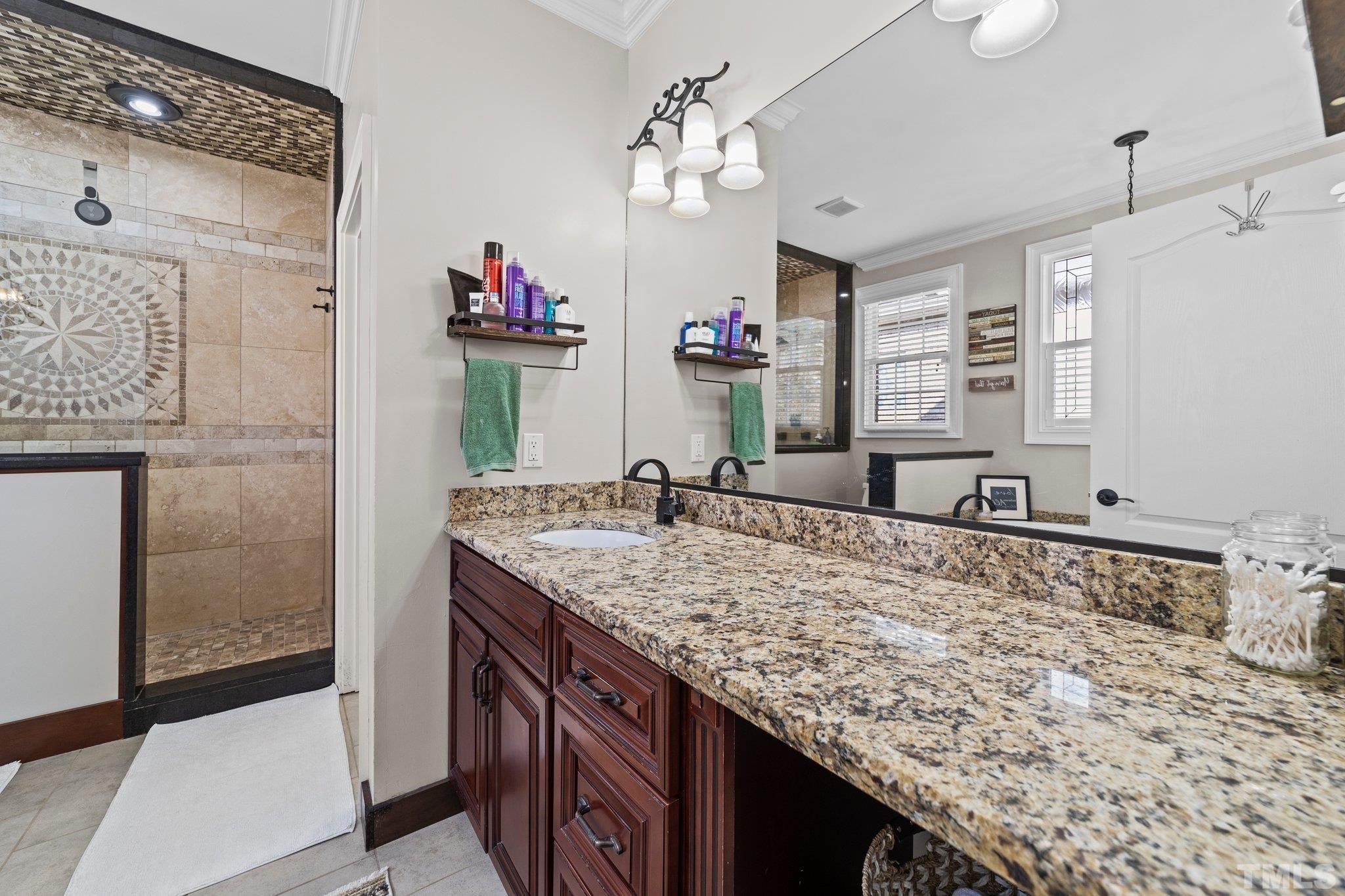213 Serendipity Drive Haw River, NC 27258 - Photo 25 of 33 a bathroom with a granite countertop sink a large mirror and a shower