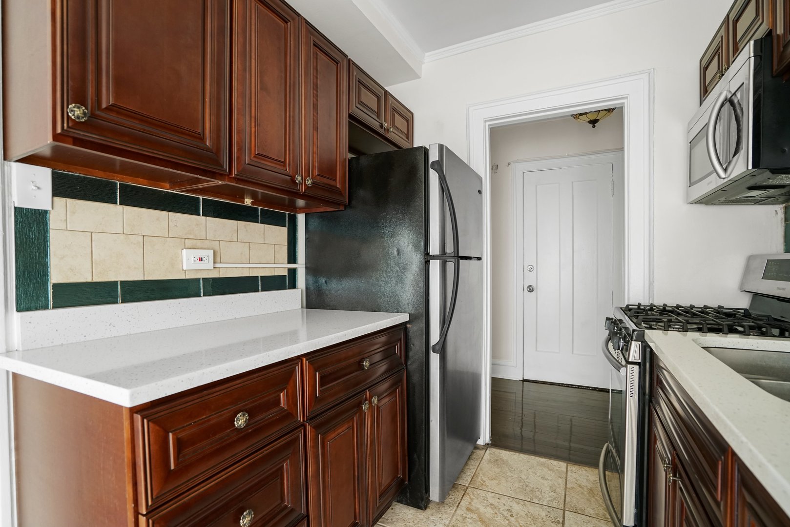 3017 East 78th Street, Unit 2B Chicago, IL 60649 - Photo 11 of 20 a kitchen with a sink and a refrigerator