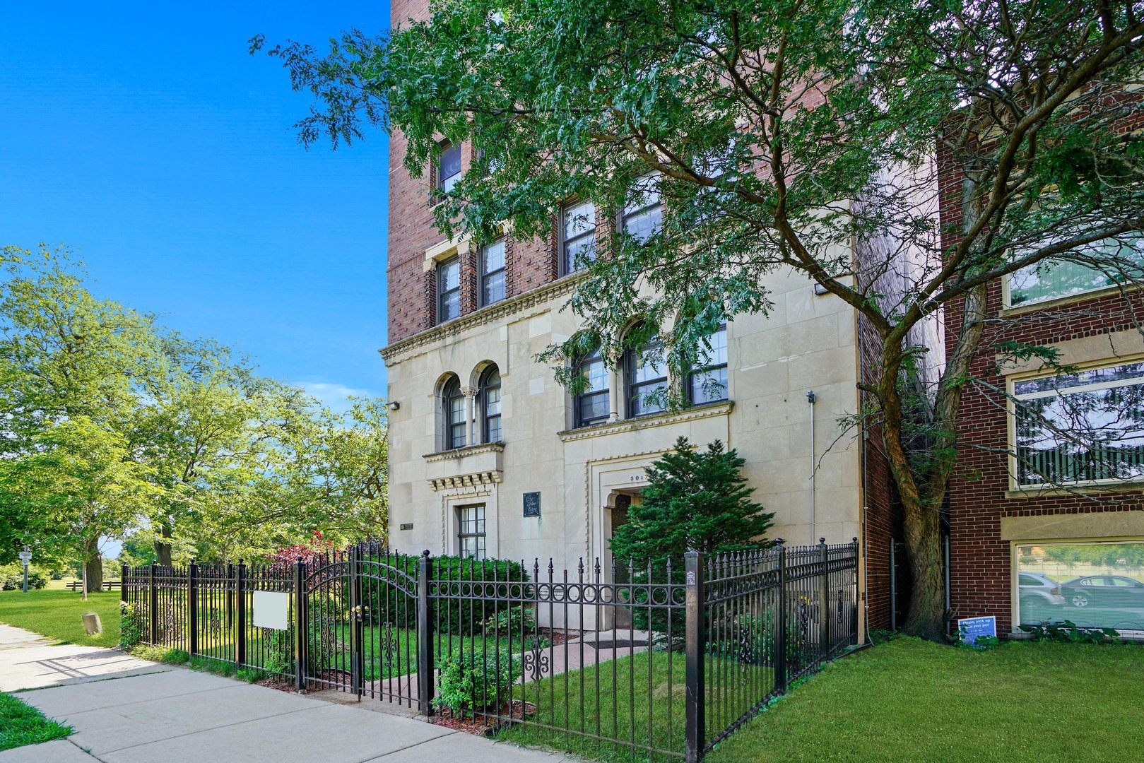 3017 East 78th Street, Unit 2B Chicago, IL 60649 - Photo 16 of 20 a view of a house with a small yard and a large tree