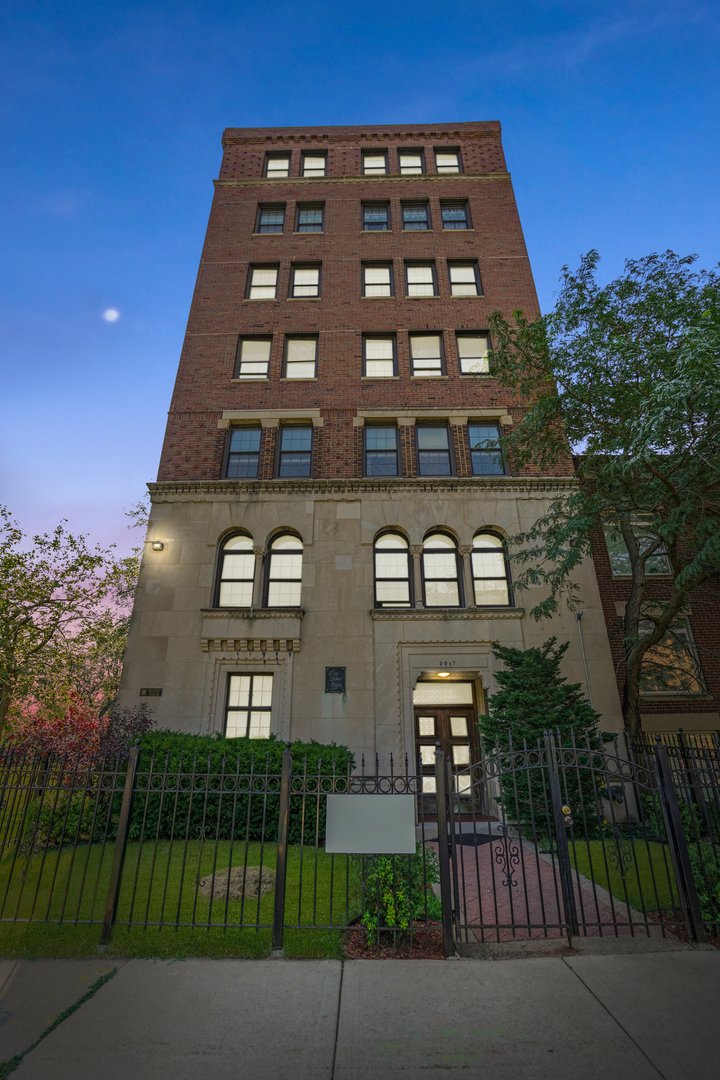 3017 East 78th Street, Unit 2B Chicago, IL 60649 - Photo 20 of 20 front view of a residential apartment building with a yard