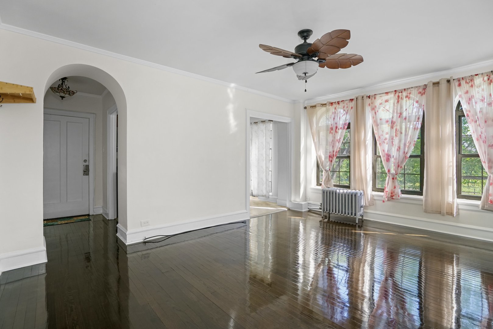 3017 East 78th Street, Unit 2B Chicago, IL 60649 - Photo 8 of 20 a view of empty room with wooden floor and fan
