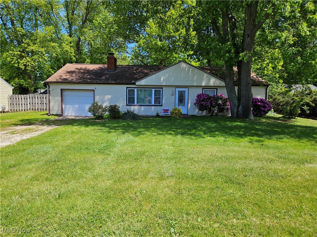 1895 Sandgate Road Madison, OH 44057 - Photo 1 of 16 Ranch-style house with an attached garage, driveway, and a chimney