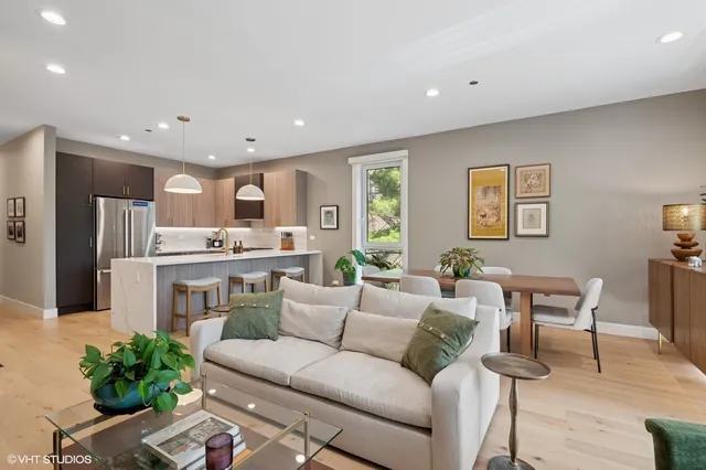 a living room with stainless steel appliances kitchen island granite countertop furniture and a view of kitchen