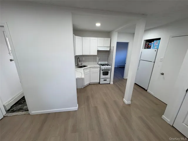 a view of kitchen with sink and wooden floor