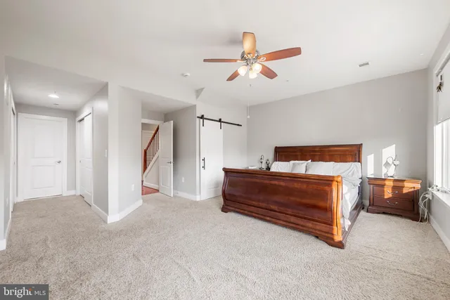 a bedroom with a bed and a chair