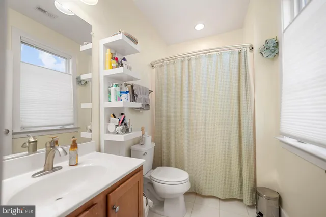 a bedroom with a bed and a potted plant