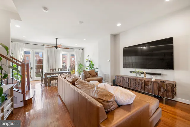 a living room with furniture fireplace and a potted plant
